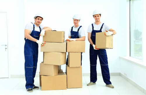 Local removals team handling furniture in Whitechapel streets